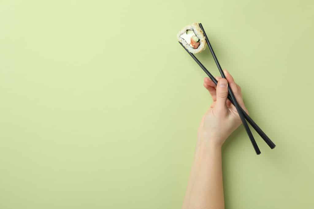 Sushi held with chopsticks